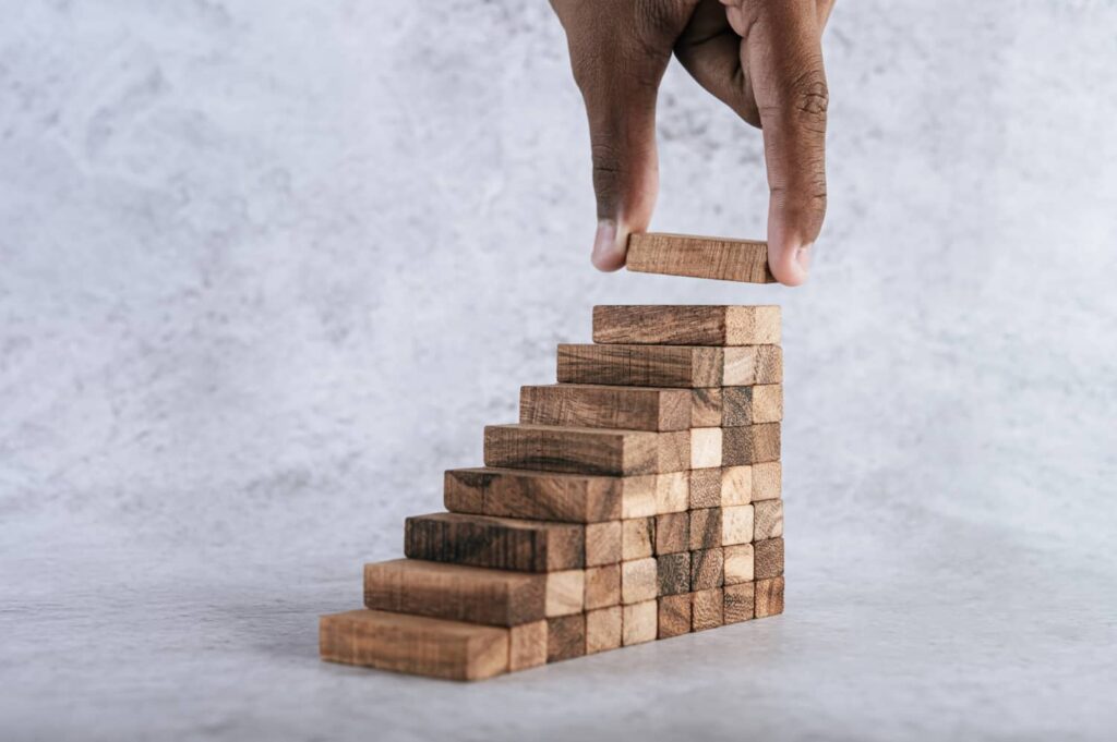 wooden Blocks setting in shape of ladder presented by SK Financial Services https://skfinancial.co