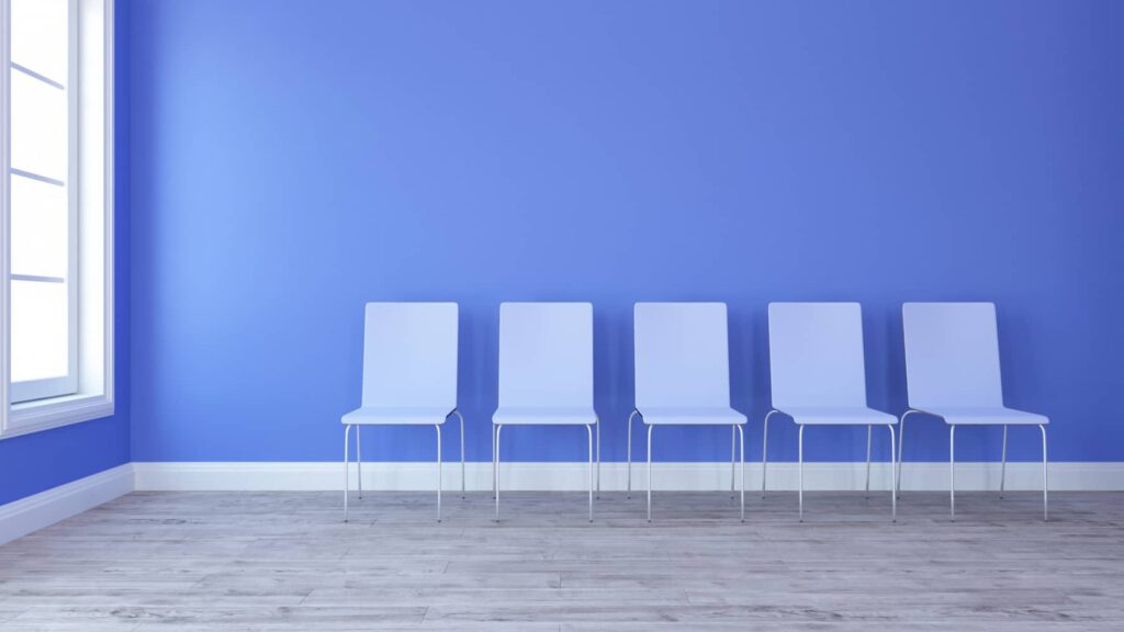 Empty chairs in room with blue color wall wooden floor white color window presented by SK Financial Services https://skfinancial.coNo Job Available