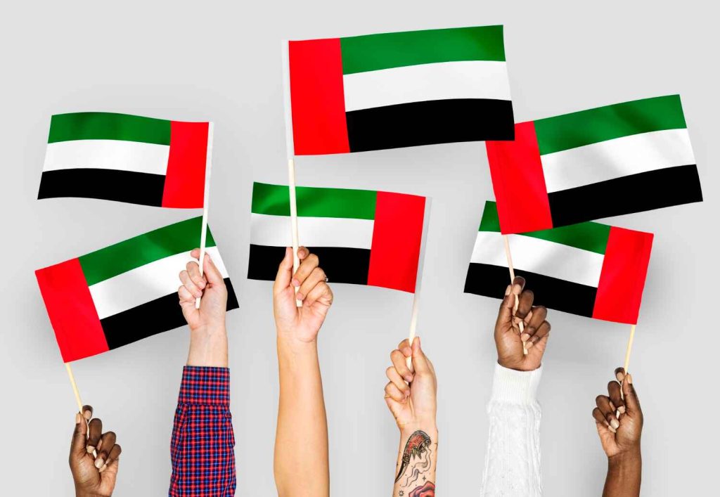 Different people waving UAE flag presented by SK Financial Services https://skfinancial.co