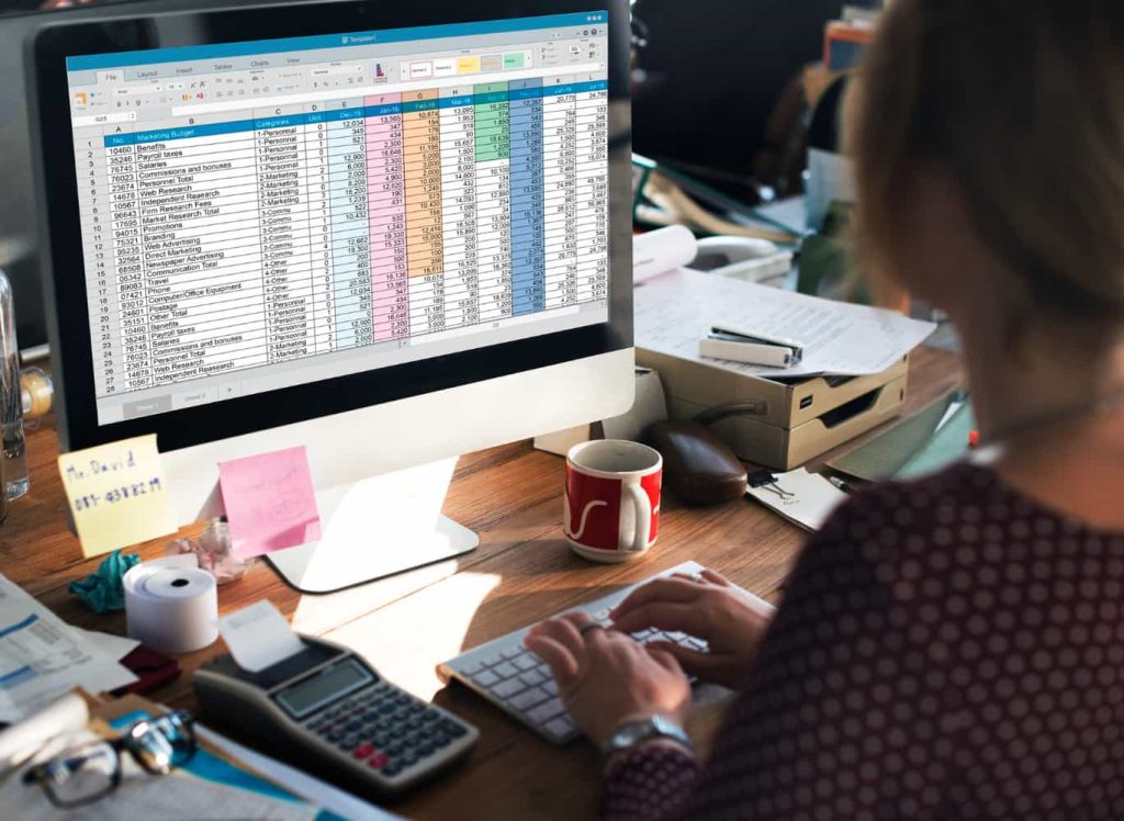 girl sitting in front of computer checking accounts and Bookkeeping presented by SK Financial Services https://skfinancial.co