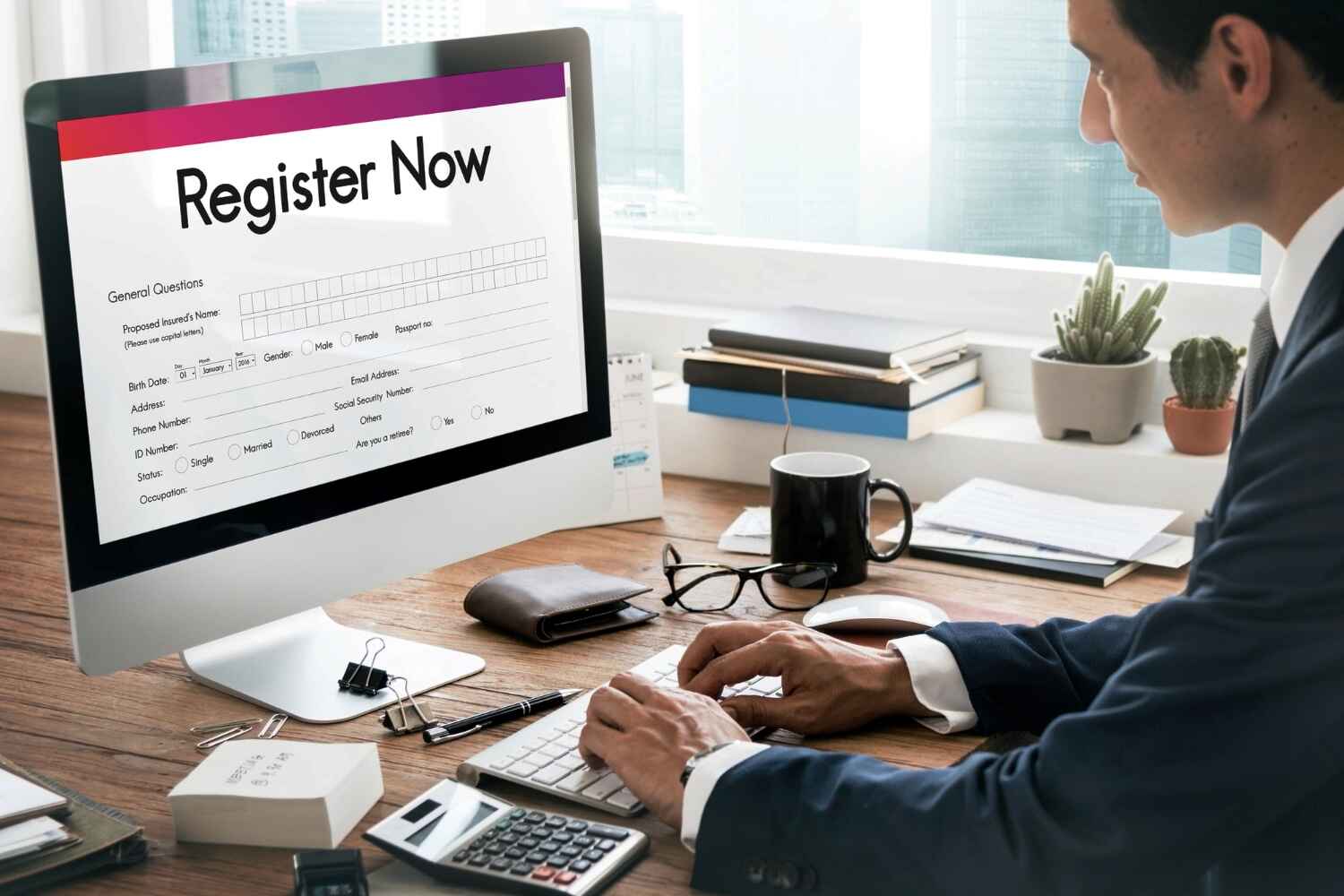 A man is enter details on computer on Register Now form, Business Registration presented by SK Financial Services https://skfinancial.co