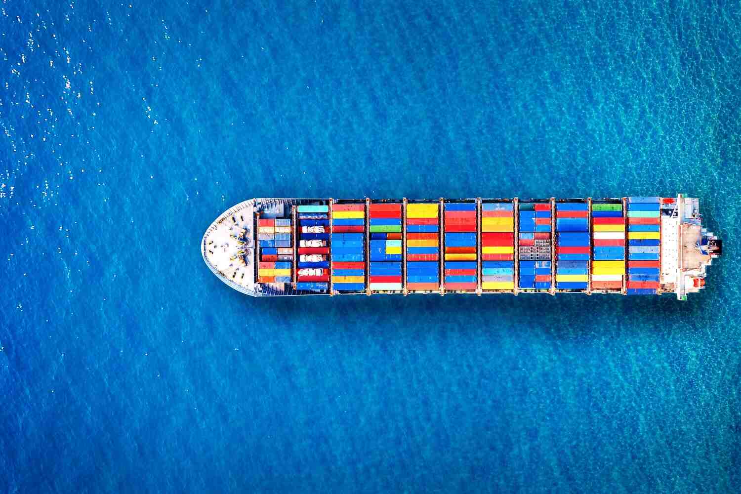 A Ship carrier full of containers moving in the blue ocean, Supply Chain in UAE presented by SK Financial Services https://skfinancial.co