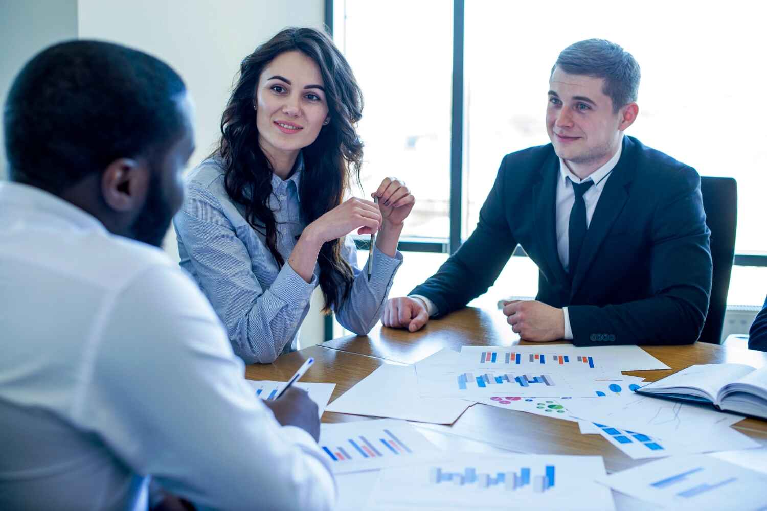 two men and one woman discussing some finance, Financial Mediation Services presented by SK Financial Services https://skfinancial.co