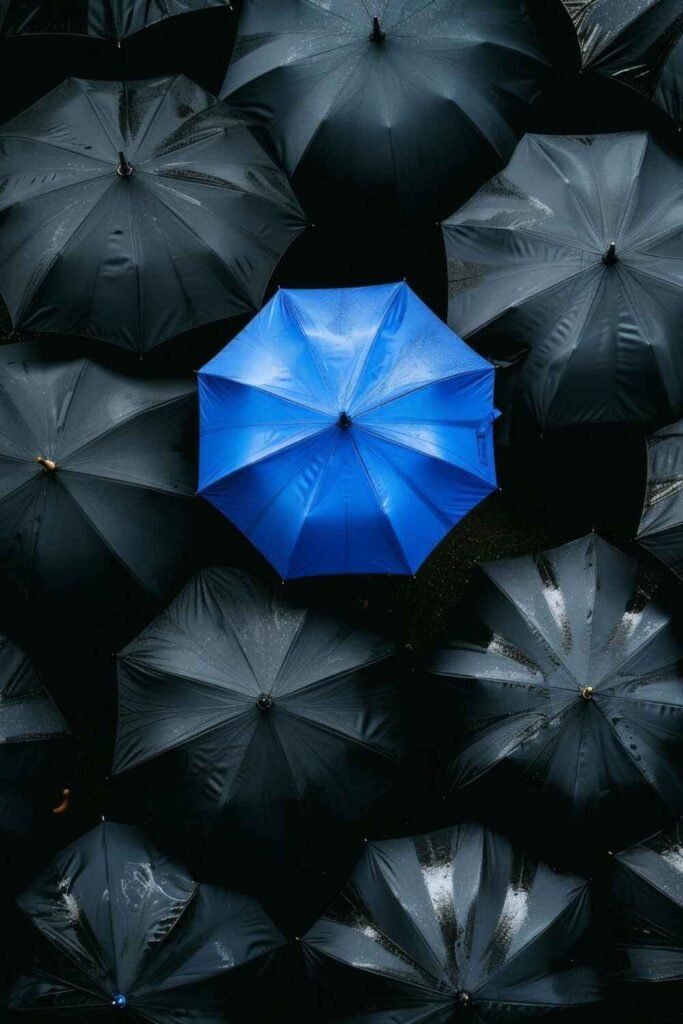 one blue umbrella among black umbrellas, Why Choose Us presented by SK Financial Services https://skfinancial.co